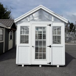 8 x 14 Greenhouse, white building with white windows on all walls and a polycoarbonate clear roof.